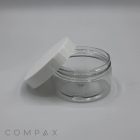 A clear, empty 120mL PET Jar with a white lid is displayed on its side. The lid is slightly tilted and leaning against the jar, providing a view of both the container and the lid. The background is plain and light-colored, with the word "COMPAX" visible at the bottom left corner.