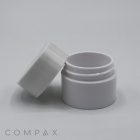 A small, white PET Jar with an unscrewed lid slightly tilted and placed to the side. The jar is empty and set against a plain, light gray background. The word "COMPAX" is faintly visible at the bottom left corner of the image.