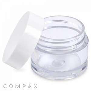 A transparent 15mL PET jar, open and empty, with a matching white lid tilted to the side. The clean jar has no visible labeling and features "COMPAX" printed at the bottom left corner of the image.