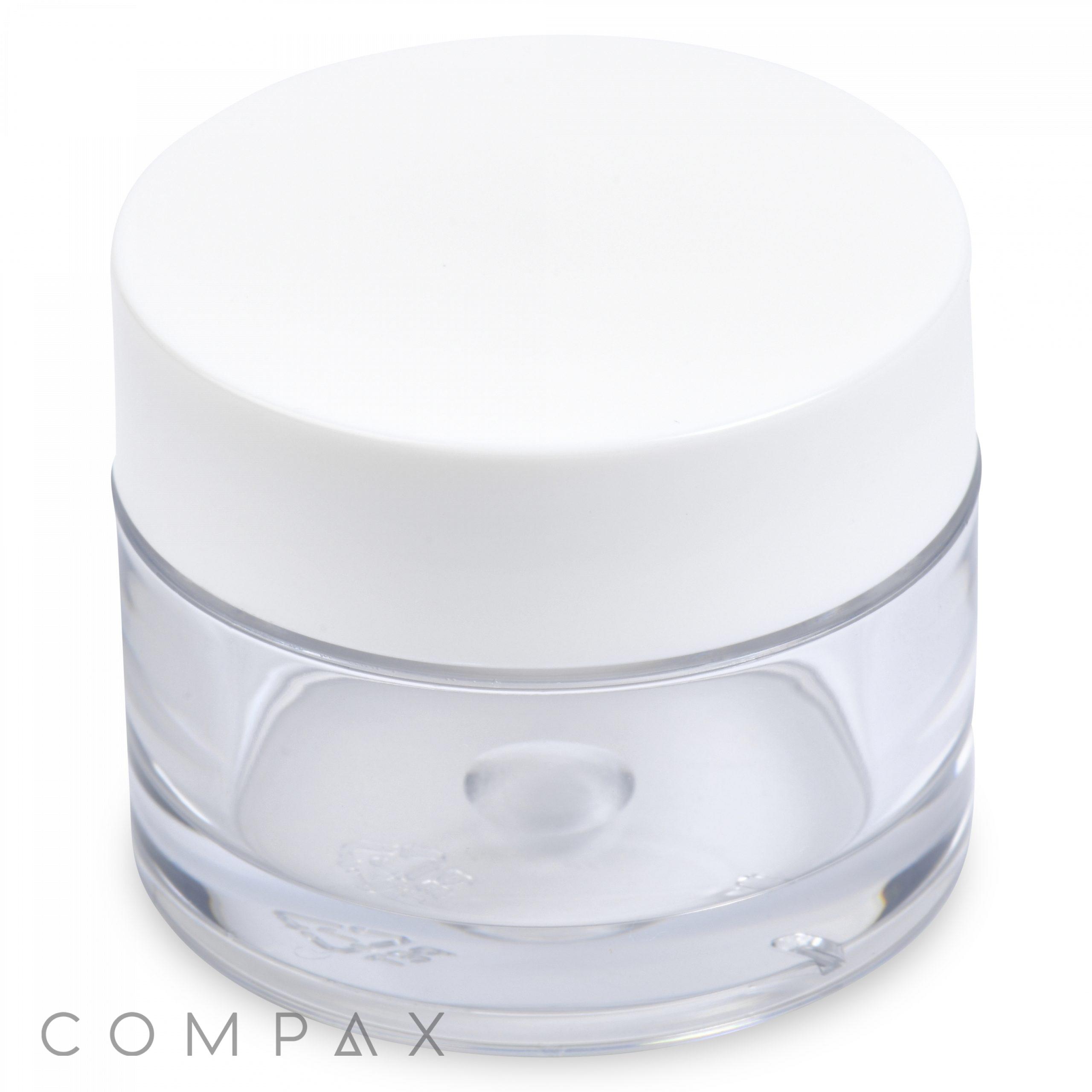 Introducing the 15mL PET Jar, a transparent round container with a white, opaque lid that creates a clean, minimalist look. The jar's clear design allows easy visibility of its contents, and the word "COMPAX" is subtly etched near the base.