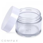A 60mL PET Jar with a clear plastic body and a white lid angled open, placed beside it. The cylindrical, transparent jar displays no contents inside, and the brand name "COMPAX" is visible in the bottom left corner.