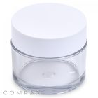 A 60mL PET Jar featuring a clear cylindrical design and a white screw-on lid. The jar is empty, boasting a smooth, minimalist aesthetic with the word "COMPAX" subtly printed near the bottom edge.