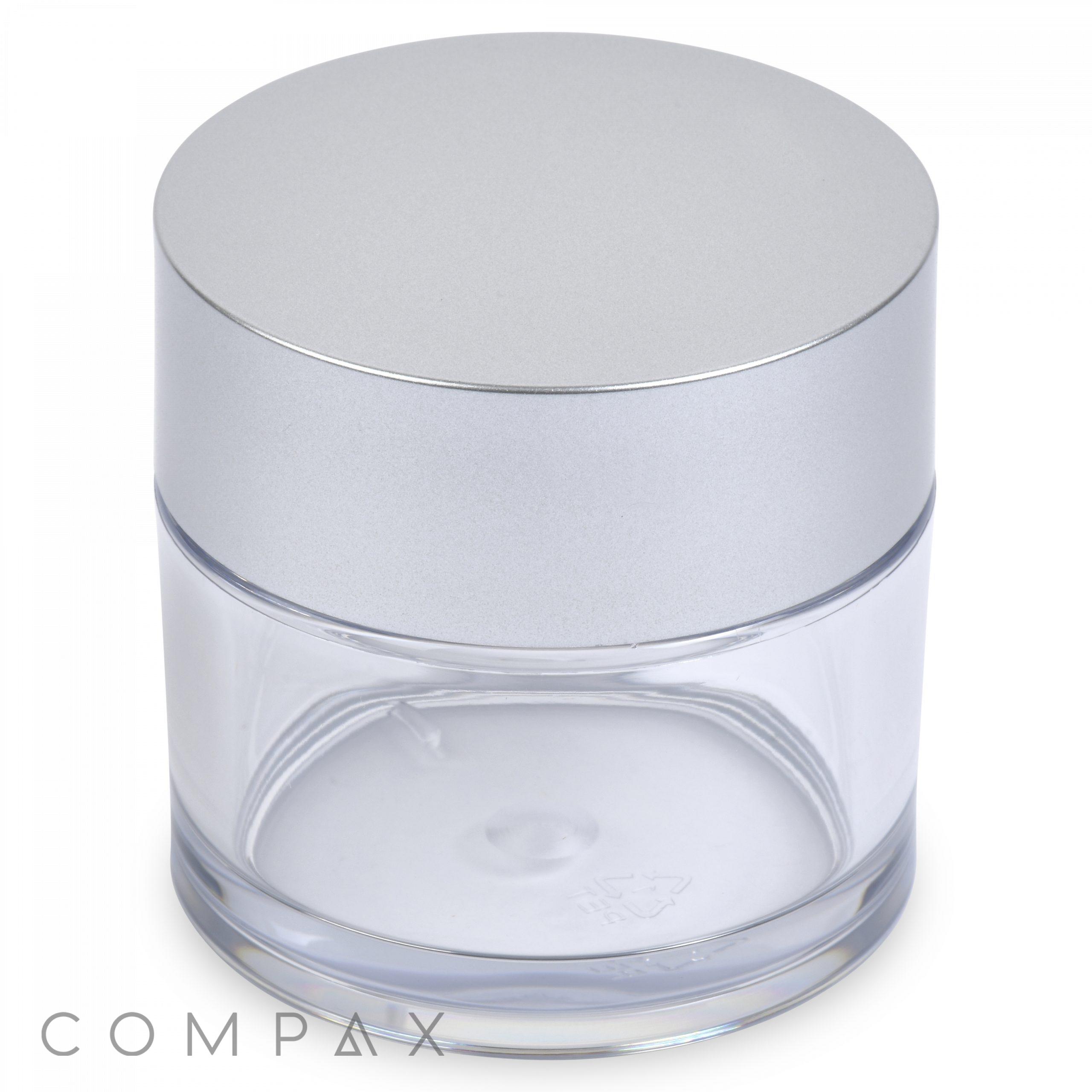 A 50mL PET Jar, featuring a clear, empty round body and a sleek silver lid, designed for storing cosmetics or skincare products. The word "COMPAX" is subtly printed in the bottom left corner against a white background.