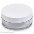 A minimalist 20mL PET jar with a wide white lid, featuring a clear cylindrical base that is completely see-through and free of labels or markings. The cosmetic container's clean design spotlights the "COMPAX" brand name in the bottom left corner.