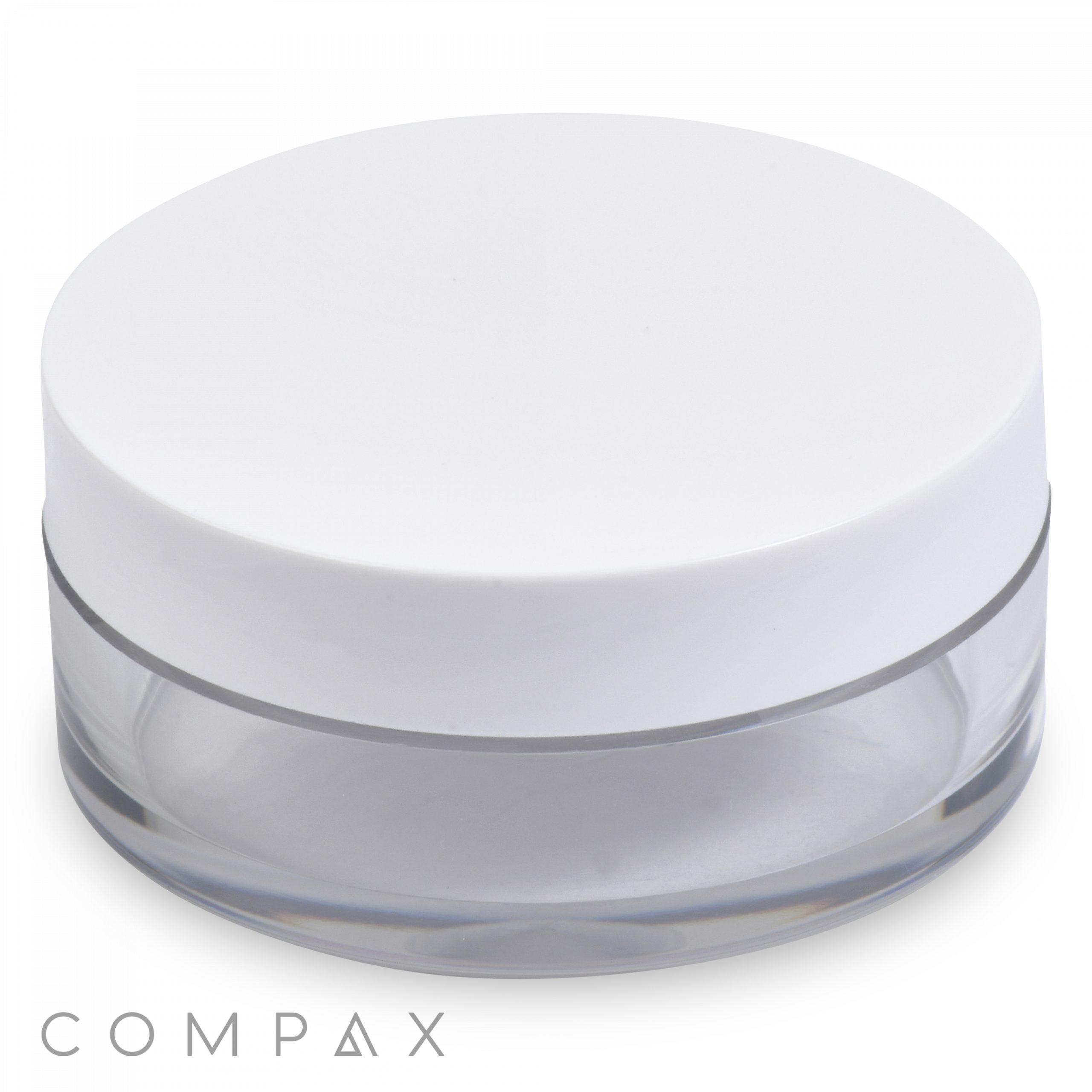 A minimalist 20mL PET jar with a wide white lid, featuring a clear cylindrical base that is completely see-through and free of labels or markings. The cosmetic container's clean design spotlights the "COMPAX" brand name in the bottom left corner.