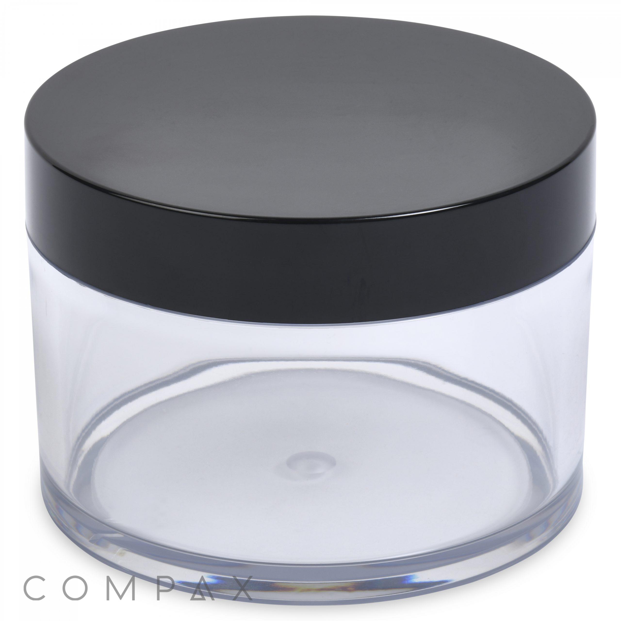 A round, clear 500mL PET jar with a flat, black lid. The jar is empty and has the word "COMPAX" printed in gray letters at the bottom left corner of the image.