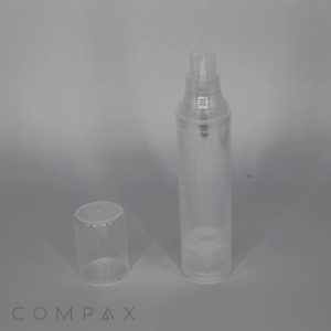 A small, clear Round Recyclable Airless Bottle is depicted with a matching transparent cap placed beside it. The background is a plain, muted grey, and the cylindrical cap fits over the nozzle of the bottle. The bottom part of the bottle is marked with "COMPAX".
