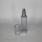 The Round Acrylic Airless Bottle, featuring a clear cylindrical design with a metallic silver pump dispenser and a removable transparent cap, is standing upright. The unbranded translucent body and cap are set against a plain white background. The word "COMPAX" is printed at the bottom left.