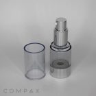 A Round Acrylic Airless Bottle with a silver and clear plastic design, featuring a cylindrical cap removed and placed to the side, stands on a plain white background. The brand name "COMPAX" is displayed in small, gray text at the bottom left corner.