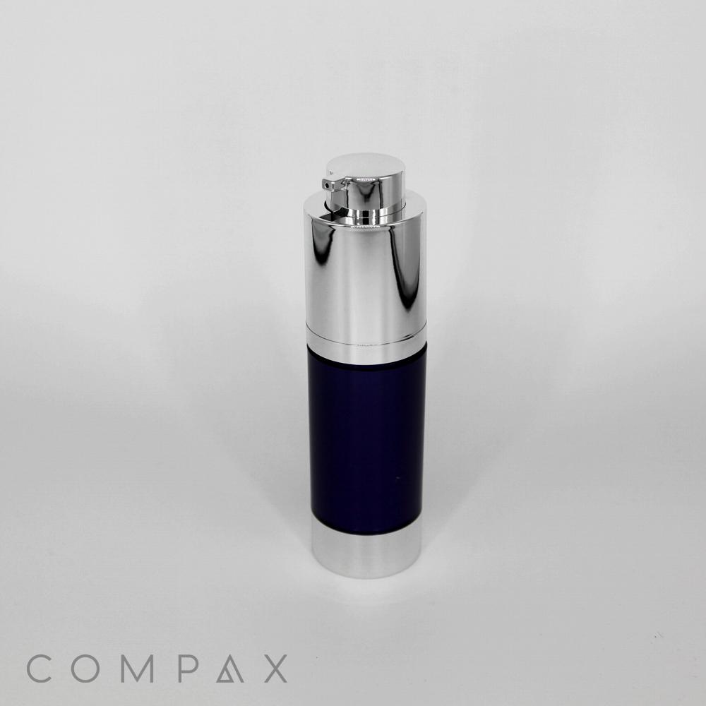 Introducing the Round Helix Pump Airless Bottle, a sleek, cylindrical container featuring a dark navy blue body with a shiny silver cap and base. The bottle is equipped with an efficient pump dispenser on top. The brand name "COMPAX" is elegantly displayed in light gray letters at the bottom left corner against a white background.