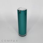A sleek, cylindrical teal Round Airless Bottle with a silver lid stands upright against a plain white background. The bottle has a minimalistic design with the brand name "COMPAX" in small text at the bottom left corner of the image.