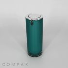 A sleek, cylindrical metallic canister with a green body and silver top designed as the Round Airless Bottle. The top features a circular button and hinge mechanism, while the base includes a small silver ring. Set against a plain white background, the word "COMPAX" is displayed in the bottom left corner.