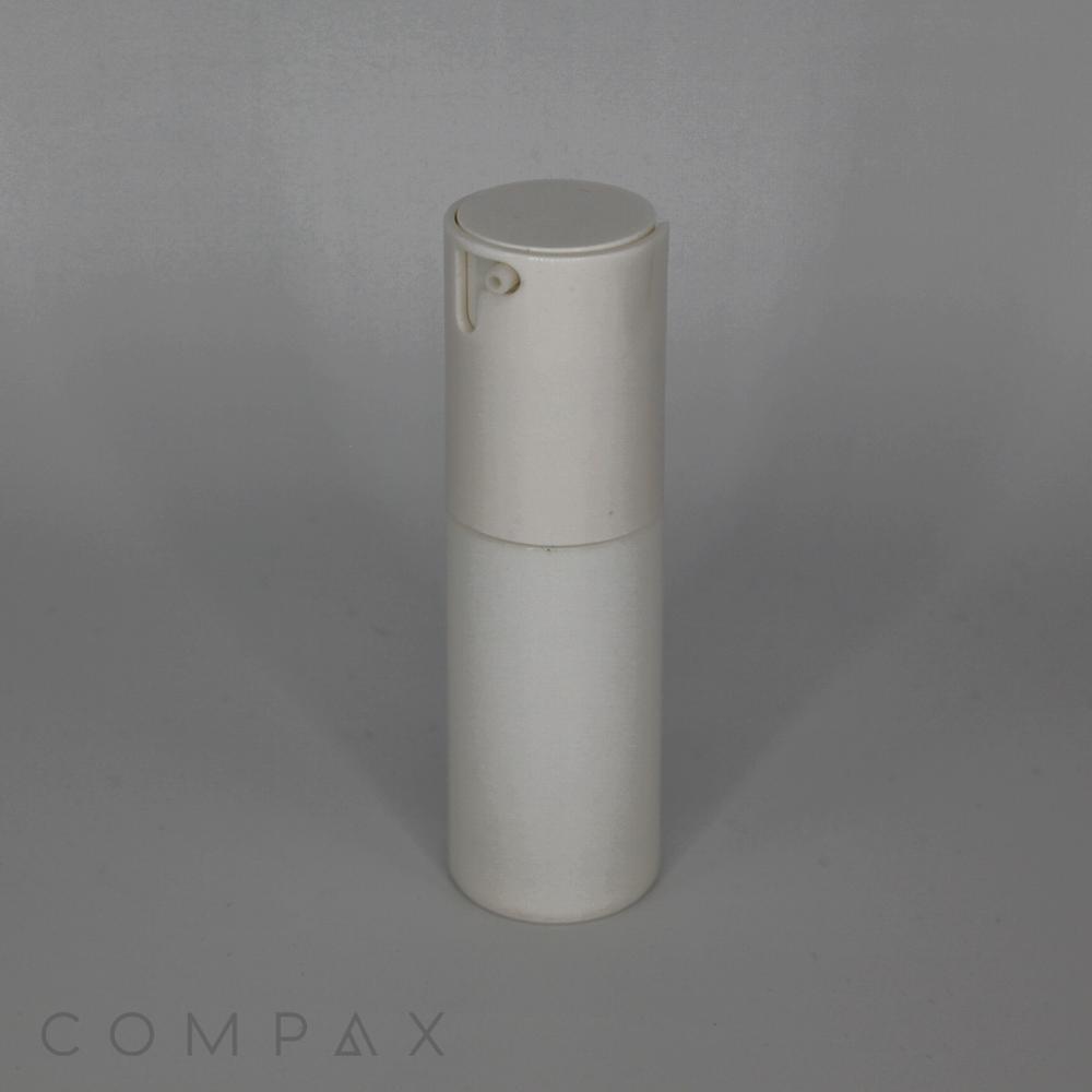 A stylish, fluted round airless bottle in pristine white, equipped with a pump dispenser, stands tall against a plain, light gray backdrop. The bottle's minimalist design boasts a smooth finish. The brand name "COMPAX" is subtly displayed at the bottom left corner of the image.