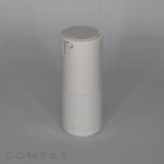 A small, cylindrical Fluted Round Airless Bottle with a rounded cap is centered against a plain gray background. The container appears to be made of plastic and may be used for storing cream or lotion. The word "COMPAX" is printed in subtle gray text at the bottom left of the image.