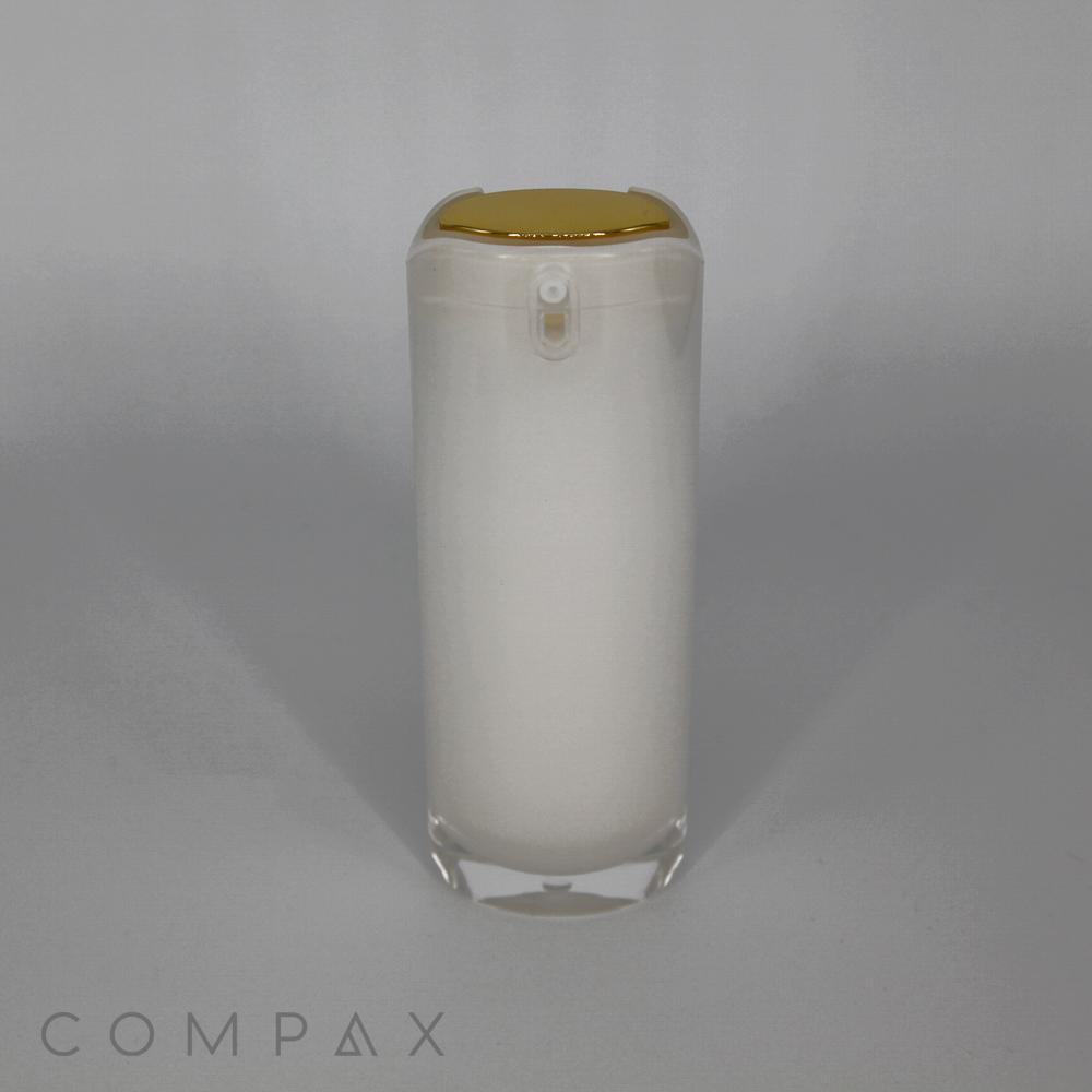 A cylindrical, frosted white Oblong Airless Bottle with a gold-colored pump dispenser on top. The bottle stands upright against a plain, light gray background. The word "COMPAX" is faintly visible at the bottom left corner.