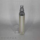 A frosted Round Airless Bottle with a silver cap and nozzle, containing a cream-colored product. The clear plastic lid is removed and placed beside the bottle against a neutral gray background. The word "COMPAX" is visible at the bottom left of the image.