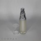A Round Airless Bottle with a frosted glass finish, featuring a silver pump dispenser and a clear plastic cap, sits on a plain background. The word "COMPAX" is visible in the bottom left corner. The cap is removed and placed next to the bottle.
