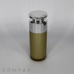 A tall, cylindrical Round Airless Bottle with a metallic silver cap and a translucent lower half, standing upright against a plain white background. The word "COMPAX" is printed in light gray at the bottom left corner of the image.