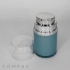 A Squatted Round Airless Bottle, blue in color with a silver pump dispenser on top and a clear plastic cap placed beside it. The container is labeled "COMPAX" in the bottom left corner, set against a plain white background.