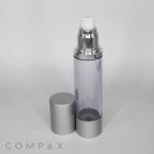 A clear, sleek Round Airless Bottle with a silver cap partially set aside reveals a silver and white pump dispenser on top. The word "COMPAX" is printed at the bottom left corner of the image.