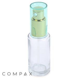 A 28mL Glass Cylinder Round Bottle, featuring a green and gold spray nozzle and topped with a translucent green cap, is shown against a white background. The word "COMPAX" is visible in gray text towards the bottom left corner of the image.