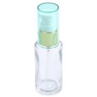 A clear 28mL glass cylinder round bottle features a teal-colored plastic pump and cap, complemented by a golden neck and a minimalistic design. The word "COMPAX" is elegantly printed in gray letters at the bottom. The background is plain white.