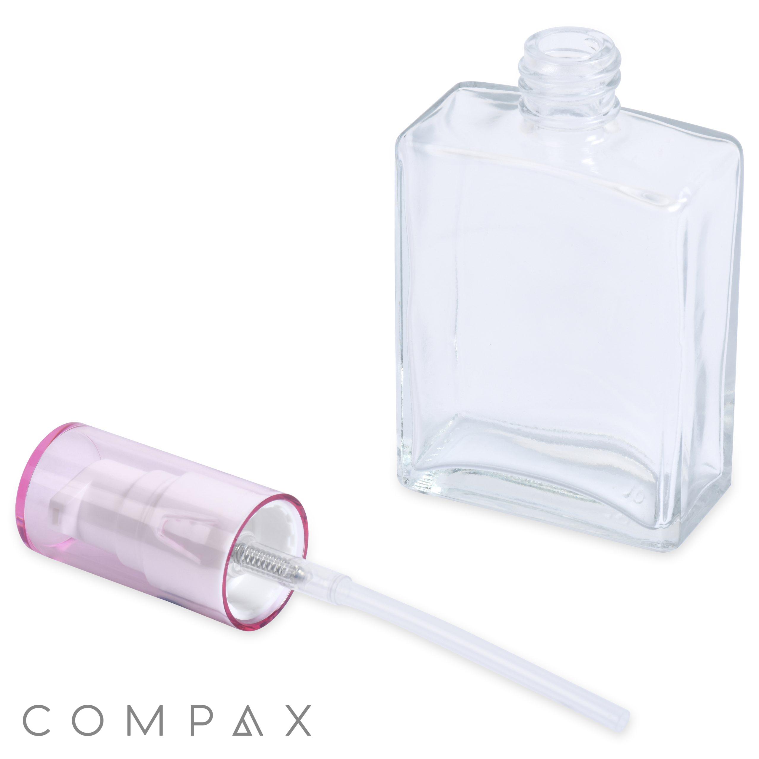 A clear rectangular 60mL glass oblong bottle featuring an attached spray nozzle and a detached pink cap positioned next to it. The nozzle tube extends inside the bottle, and the word "COMPAX" is displayed at the bottom left of the image.