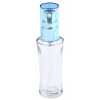 The 30mL Glass Fluted Bottle is a transparent spray bottle with a blue cap, featuring a silver pump mechanism. It boasts a sleek, curved design and is currently empty. The word "COMPAX" is displayed in gray lettering at the bottom left corner of the image.
