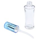 A clear, empty 30mL glass fluted bottle with a detachable metallic blue spray nozzle lies on its side, displaying the internal straw mechanism. The compax brand name is displayed in lowercase at the bottom of the image.