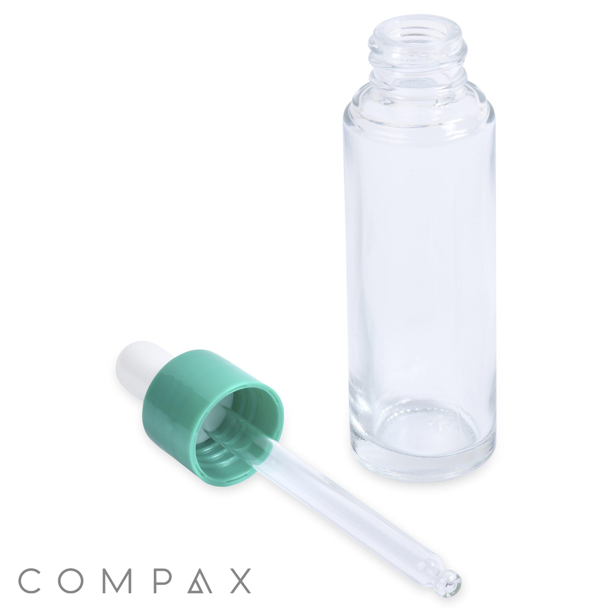 A 30mL Glass Cylinder Round Bottle with an open top is positioned upright. A light green dropper with a white rubber top is placed in front of the bottle, laying sideways. The word "COMPAX" appears in the lower left corner of the image.