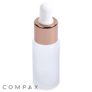 A 15mL Glass Cylinder Round Bottle with a frosted finish, metallic rose gold cap, and white rubber top is pictured. The bottle is standing upright, with the word "COMPAX" printed in black in the lower-left corner of the image.