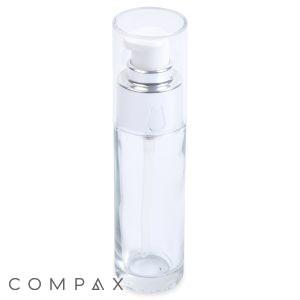 A 30mL Glass Cylinder Round Bottle with a transparent build, clear cap, and silver pump. The bottle is empty and features the word "COMPAX" in gray letters at the bottom left corner.