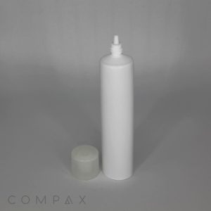 A 30mm No-Drip Airless Valve Tip Tube, in an upright white squeeze bottle with a small nozzle, is displayed on a grey surface. The semi-transparent round cap of the bottle is positioned next to it. In the bottom-left corner, the word "COMPAX" is visible.