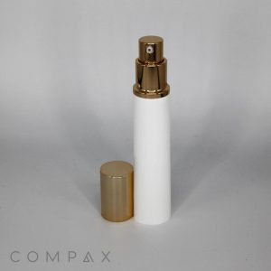 A white cylindrical 25mm Airless Pump Tube featuring a glossy gold spray nozzle and cap. The cap is positioned to the left of the tube on a flat surface. The background is plain and light gray, with the word "COMPAX" visible in the lower left corner of the image.
