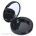 A Round Platform Single Pan Eyeshadow Compact, black and circular with a mirror inside the lid, is open to show an empty compartment. The word "COMPAX" appears in the bottom left corner of the image.