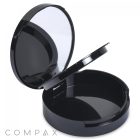 The Round Single Pan Compact with Brush Well is a black makeup compact that features a lid which opens to unveil a mirror on the inside. The lower-left corner displays the word "COMPAX." Inside, there is an empty circular compartment.