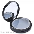 A black Round Airtight Compact case with an open lid revealing a clear plastic cover over an empty pan, designed to hold makeup. The underside of the lid features a mirror for convenient application. The word "COMPAX" is printed in gray at the bottom left corner.