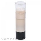 A white cylindrical container with a transparent cap and a black base, likely containing a solid product such as deodorant or skincare. The word "COMPAX" is faintly visible at the bottom left corner of the image.