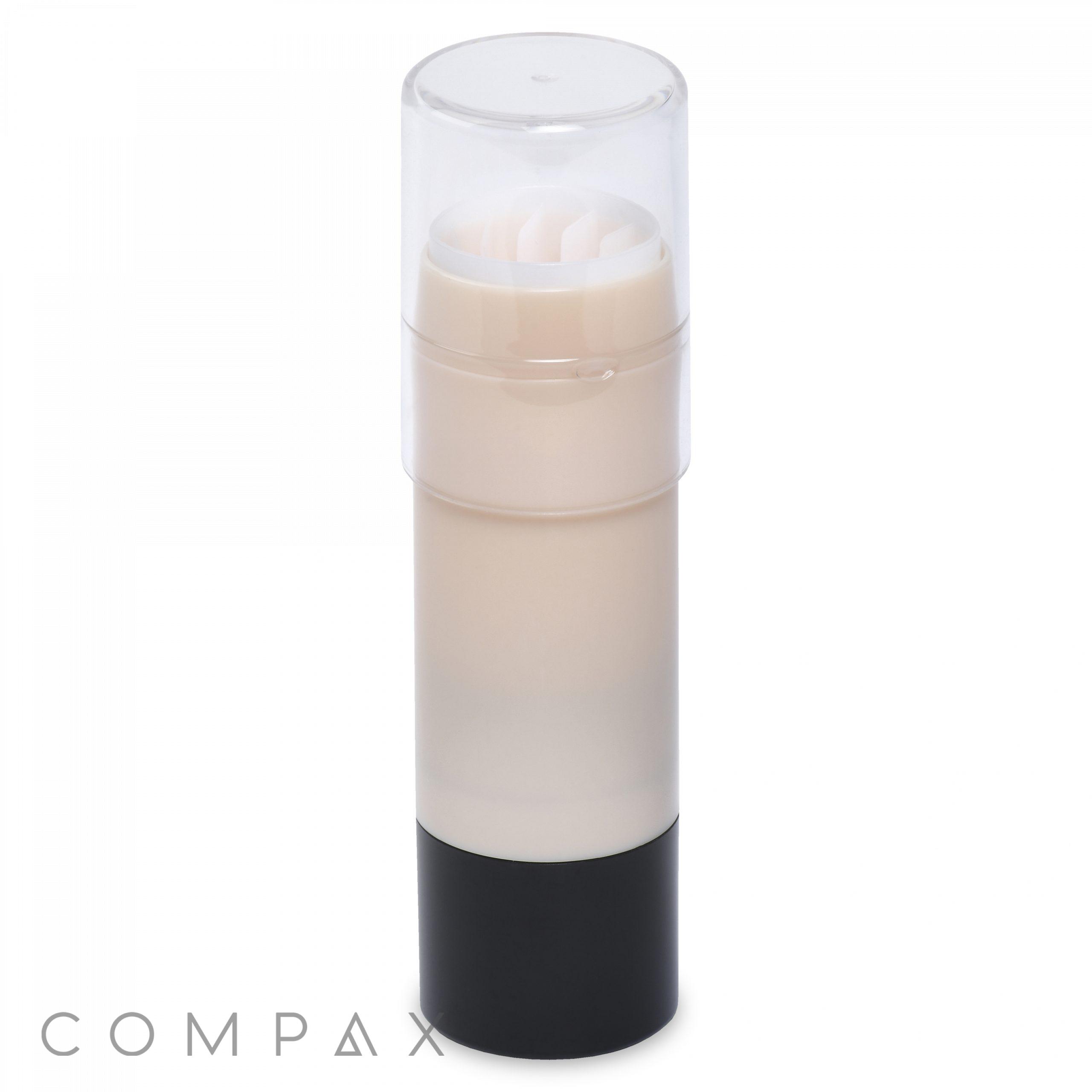 A white cylindrical container with a transparent cap and a black base, likely containing a solid product such as deodorant or skincare. The word "COMPAX" is faintly visible at the bottom left corner of the image.