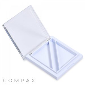 A sleek white plastic container with a transparent hinged lid displayed open. Inside, there are three triangular compartments. The name "Square 2 Pan Compact with Brush Well" is visible in light gray text at the bottom left corner.