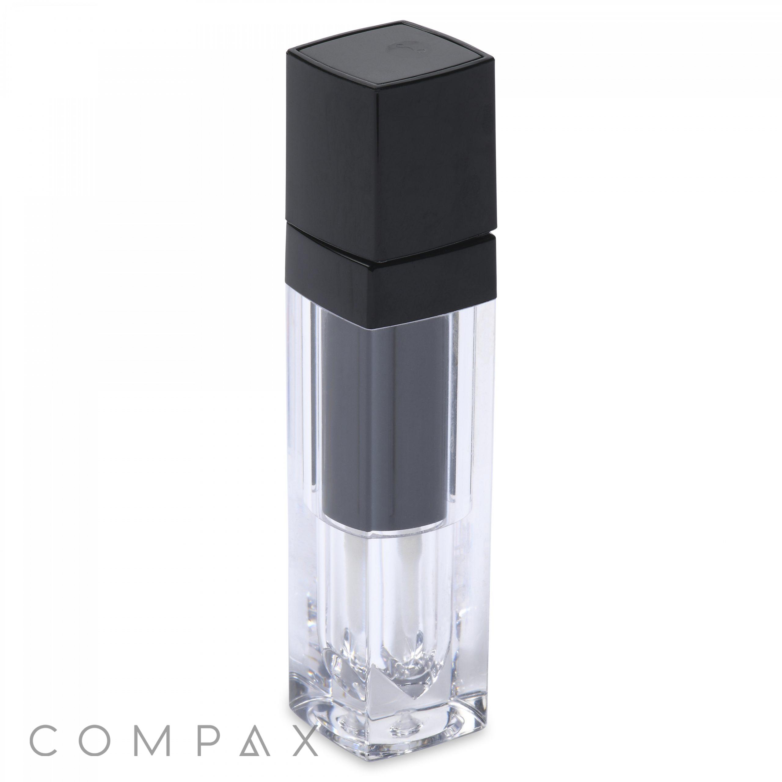 A sleek, transparent square lip gloss bottle with a black cap. The bottle features a minimalist design and the word "COMPAX" is displayed in gray text at the bottom left corner.