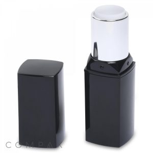 The Square Lipstick, encased in a glossy black container with a metallic silver twist-up mechanism, is displayed. The cap has been removed and placed next to the tube, showcasing the white-colored lipstick or balm inside.