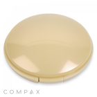 A round, beige "Round Single Pan Compact" case with a glossy finish is closed and features a hinge at the bottom. The background is white, and the brand name "COMPAX" is partially visible in gray text at the lower left corner of the image.