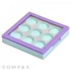 The 9 Well Square Compact is a pastel-colored eyeshadow palette featuring a transparent lid, a purple border, and a light green base. It contains nine empty circular slots for eyeshadow pans, with the brand name "COMPAX" displayed in the bottom left corner.