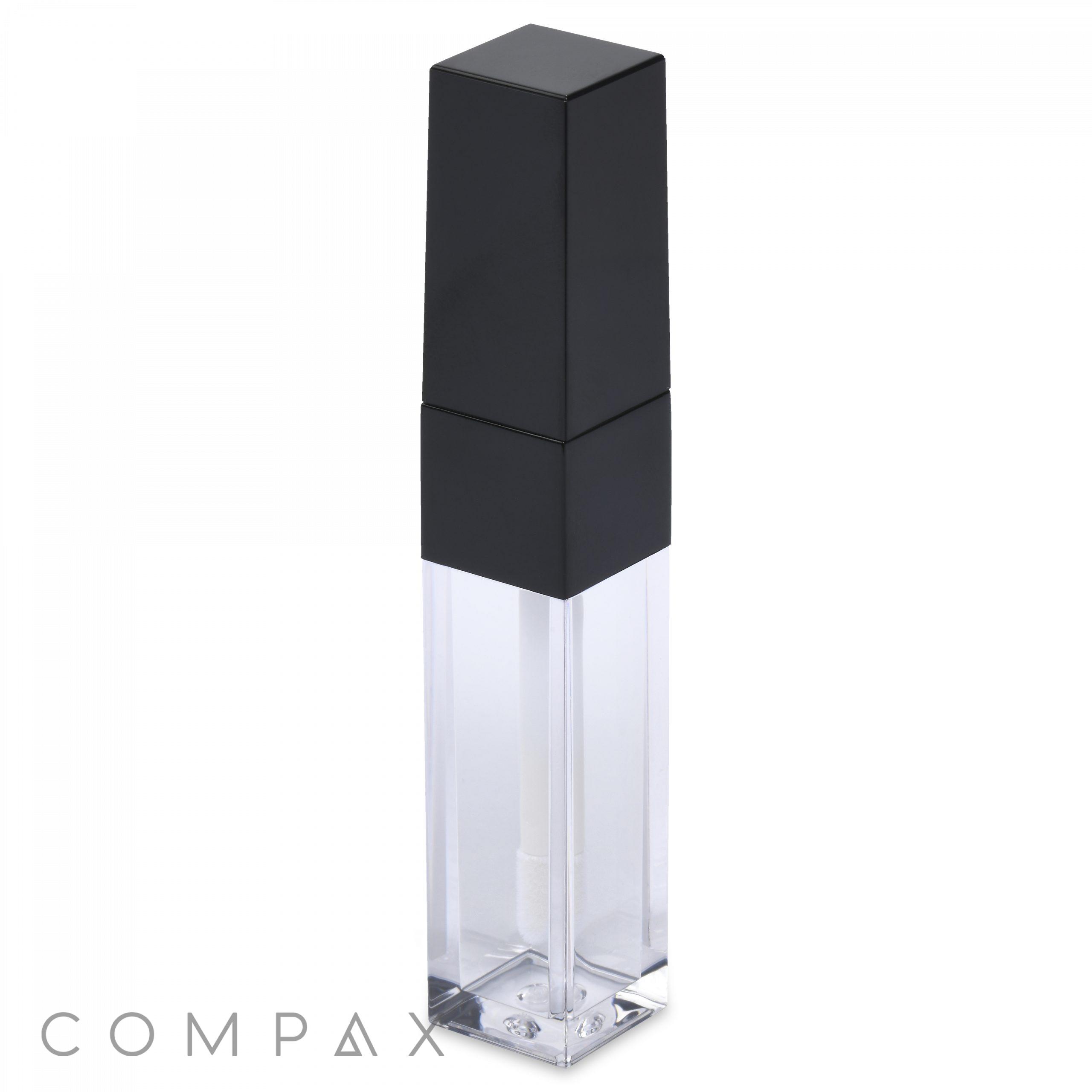 A sleek, transparent Square Lip Gloss tube featuring a black, angular cap. The tube appears nearly empty, highlighting its minimalistic and modern design. The "COMPAX" logo is subtly branded in the bottom left corner.