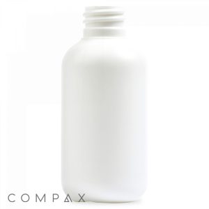 A 2oz Boston Round Bottle made from white plastic features a cylindrical shape and a ribbed screw cap opening at the top. The bottle is plain and unlabelled, with the word "COMPAX" printed at the bottom left corner. The background is plain white.