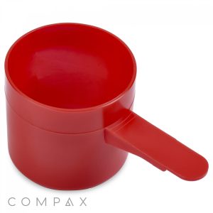 A red plastic 63cc scoop with a handle is shown. The scoop is cylindrical and has a flat base. The handle is short and sturdy. Below the scoop, the brand name "COMPAX" is printed in gray letters.