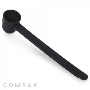 1.5cc Scoop: This black plastic coffee scoop, featuring a long handle, is specifically designed for measuring out coffee grounds. The word "COMPAX" is displayed in gray text at the bottom left corner of the image.