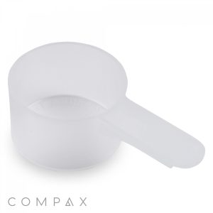A translucent plastic 18cc scoop with a handle, placed on a white background. The branding "COMPAX" is seen at the bottom of the image.