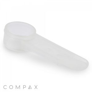 The 1.25cc Scoop features a clear plastic cap designed for easy attachment and removal. The cap includes a spout-like structure to ensure a secure fit on the container, making it suitable for both medical and personal use. The background is white with the word "COMPAX" positioned in the bottom left corner.
